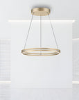 Gold pendant kinetic light fixture hanging in a modern interior setting