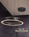 Modern kinetic pendant lights with circular design hanging from the ceiling.