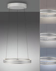 Modern kinetic pendant light with three circular rings on a gray background