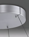 Close-up of a modern ceiling kinetic light fixture with a dark background