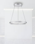 Modern pendant kinetic light fixture hanging from the ceiling in a minimalistic interior.