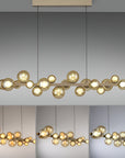 Modern kinetic chandelier with gold bulbs on a gray background showing different colour temperatures