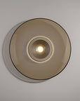 Round ceiling light fixture on a plain wall