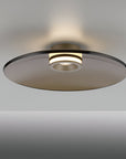 Modern wall light fixture with a glass shade on a gray background