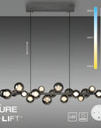Neuhaus Pure e-Lift chandelier with color temperature and brightness control indicators on a gray background.