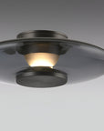 Ceiling light fixture with glass shade on a gray background