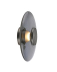 Decorative wall light fixture with a metallic finish on a white background