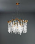 Chandelier with gold frame and clear glass elements on a dark gray background