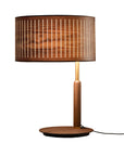 Wooden table lamp with a wooden brown shade and brass detailing on a white background from Nomon available at Spacio retail stores in Mumbai & Kolkata.