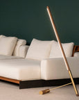 Modern living room with a beige sectional sofa and a tall, thin floor lamp.