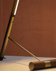 Wooden floor lamp in walnut wood and brass from Nomon available at Spacio retail stores in Mumbai & Kolkata.