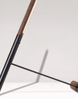 Modern floor lamp with wooden accents on a white background