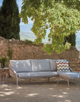A Sifas Basket Sofa Collection, placed in front of a stone wall, from the Sifas brand.