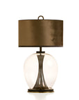 Table lamp with bronze shade and glass base on a white background from Pieter Adam available at Spacio in India.