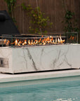 Outdoor setting with lounge chairs and a fire pit by a pool