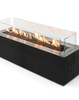 Modern black gas fire pit table with glass cover on a white background