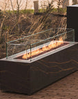 Outdoor gas fire place with flames on a brick patio from Planika available at Spacio retail stores in Mumbai & Kolkata.