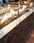 Fire pit on a brick patio with people in the background