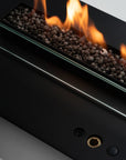Planika's Modern bioethanol insert fireplace with glass front and visible flames on a neutral background available at Spacio retail stores in India