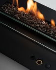 Planika's Modern bioethanol insert fireplace with glass front and visible flames on a neutral background available at Spacio retail stores in India