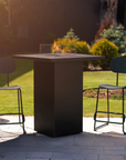 Outdoor gas fire table with chairs on a patio