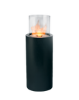 Black cylindrical fire pit with glass cover on a white background from Planika for Indoor and outdoor space available at Spacio retail stores in Mumbai & Kolkata