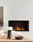 Modern living room with a artificial water vapour fireplace, sofa, and decorative items.