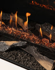 Close-up of a fireplace with burning logs and flames.