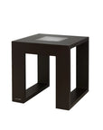 Black solar light side table with glass top on a white background