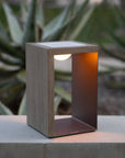 Modern outdoor indoor solar light lantern on a concrete surface with plants in the background by Les Jardins available at Spacio retail stores in India.