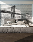 A hand-sketched fresco mural of the Manhattan Bridge in New York, crafted on Italian plaster with Carrara marble and Roman travertine for a luxury finish. Featured on a modern bedroom wall