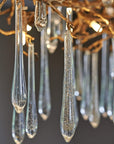 The Serip Aqua Chandelier by Serip features a stunning arrangement of glass drops, creating a nature-inspired and mesmerizing display.