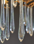 The Serip Aqua Chandelier by Serip features a stunning arrangement of glass drops, creating a nature-inspired and mesmerizing display.