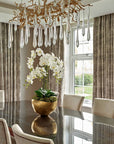 A dining room with a nature-inspired Serip Aqua Chandelier from Serip hanging over the table.