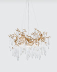 A Serip Aqua Chandelier, part of Serip's Aqua Collection, hanging elegantly on a white wall.