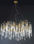 A Serip Aqua Chandelier adorned with clear crystal drops is suspended elegantly from the ceiling.