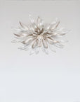 Decorative ceiling light with a starburst design on a plain background