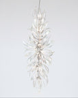 A grand chandelier in the shape a of a forest flower bloom on a light grey colour background