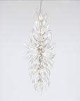 A grand chandelier in the shape a of a forest flower bloom on a light grey colour background