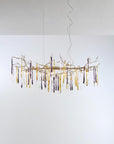 A chandelier hanging from the ceiling with colourful icicles shape glass on a light grey colour background