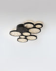 Modern ceiling light fixture with multiple round lights on a white background
