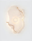 Decorative wall light with gold accents on a white background