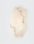 Decorative wall light fixture with a soft glow on a white background