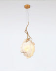 Modern pendant light with a white mabrle and gold metal fixture on a white background