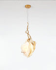 Modern pendant light with gold fixture and marble on a white background