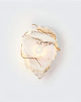 Marble wall sconce with gold accents on a white background