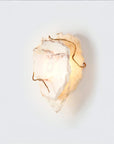 Decorative wall sconce with marble and gold finish on a white background