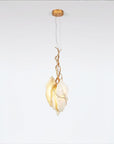 Modern pendant light with gold finish fixture and marble on a white background