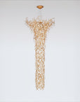 Gold chandelier hanging against a white background