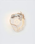 Decorative wall light with marble and gold metal finish accents on a white background